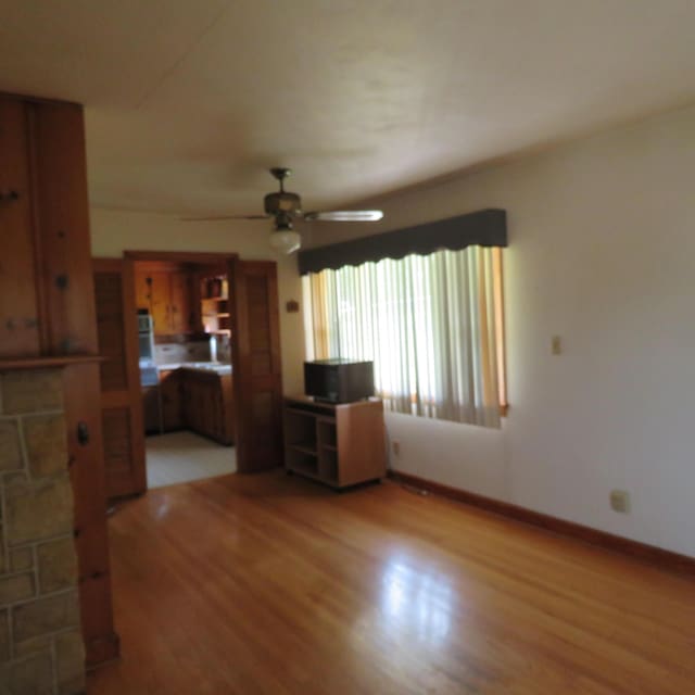 383 Main St, New Castle, VA 24127 - unfurnished living room featuring light wood-style floors, ceiling fan, and baseboards
