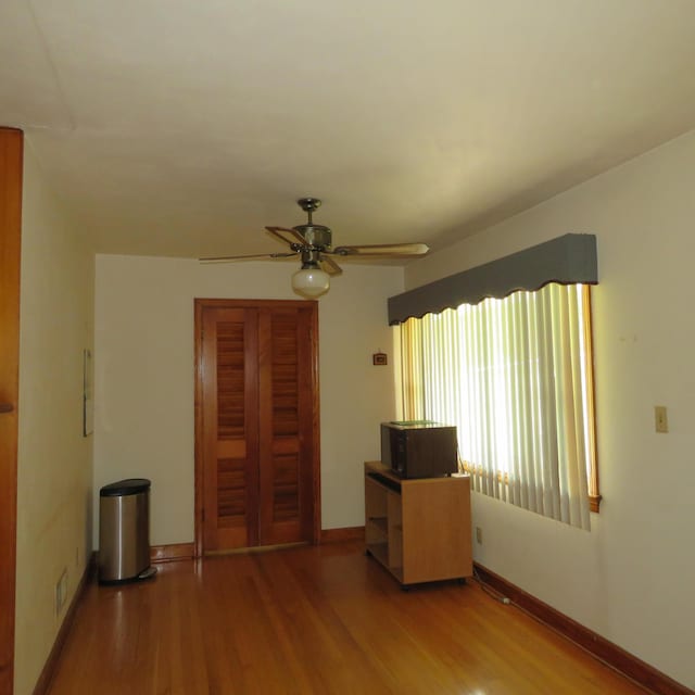 383 Main St, New Castle, VA 24127 - empty room featuring wood finished floors, a ceiling fan, and baseboards