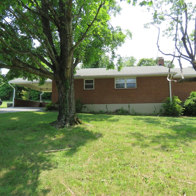 383 Main St, New Castle, VA 24127 - view of property exterior featuring brick siding, a chimney, a yard, and a carport