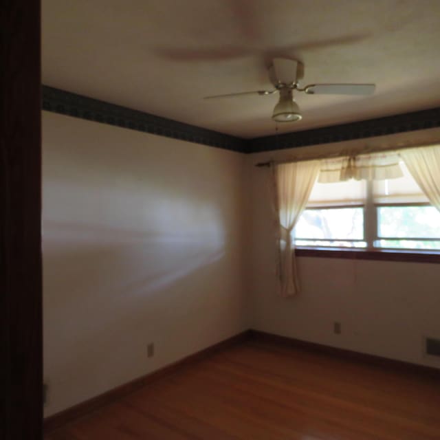 383 Main St, New Castle, VA 24127 - spare room with dark wood finished floors, ceiling fan, and baseboards