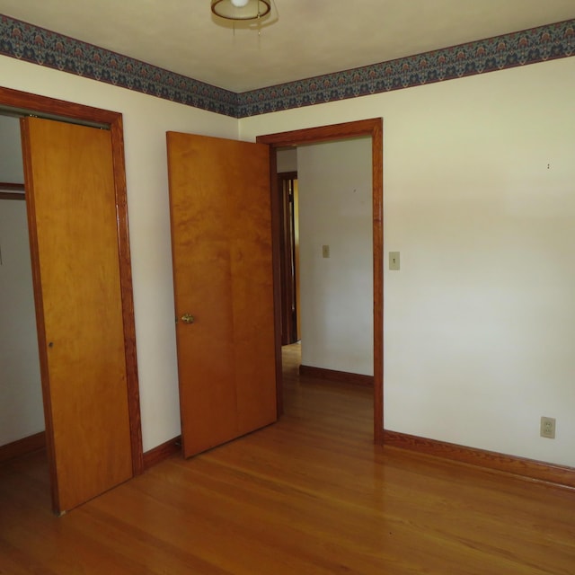 383 Main St, New Castle, VA 24127 - unfurnished bedroom with wood finished floors, baseboards, and a closet