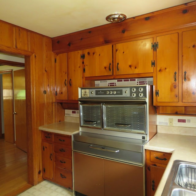383 Main St, New Castle, VA 24127 - kitchen with oven, light countertops, brown cabinets, and light floors