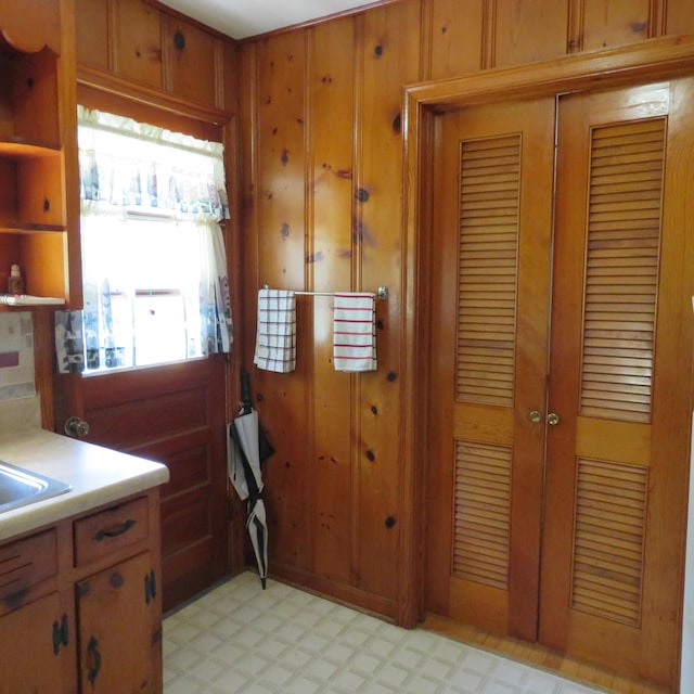 383 Main St, New Castle, VA 24127 - kitchen with light flooring, brown cabinets, light countertops, and wood walls