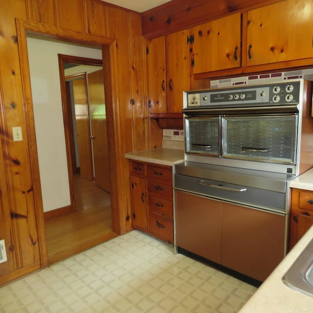 383 Main St, New Castle, VA 24127 - kitchen featuring stainless steel oven, light floors, light countertops, and brown cabinetry