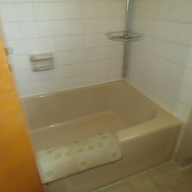 383 Main St, New Castle, VA 24127 - bathroom with tile patterned floors, a tub to relax in, and a shower