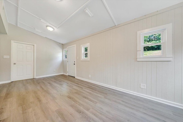 2109 Colgate St NE, Roanoke, VA 24012 - spare room featuring wood finished floors, vaulted ceiling, baseboards, and wooden walls