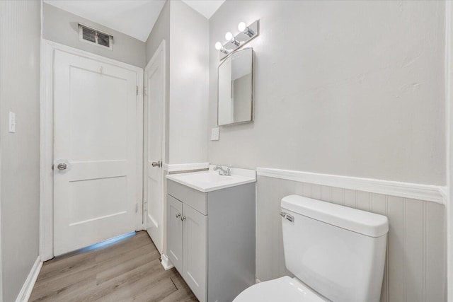 2109 Colgate St NE, Roanoke, VA 24012 - half bathroom featuring vanity, wood finished floors, toilet, and wainscoting