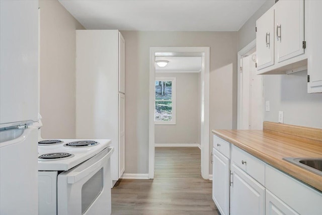 2109 Colgate St NE, Roanoke, VA 24012 - kitchen with white appliances, baseboards, light wood-type flooring, and white cabinets
