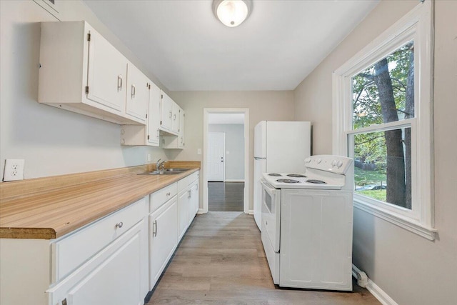 2109 Colgate St NE, Roanoke, VA 24012 - kitchen featuring white electric range, a sink, light wood-style flooring, baseboards, and plenty of natural light