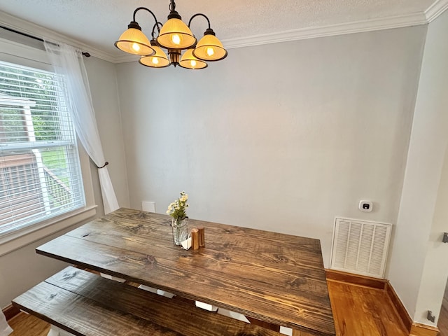 2436 Lofton Rd SW, Roanoke, VA 24015 - dining room featuring a chandelier, healthy amount of natural light, wood finished floors, crown molding, and baseboards