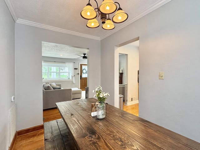 2436 Lofton Rd SW, Roanoke, VA 24015 - dining area featuring light wood finished floors, ornamental molding, a chandelier, baseboards, and a ceiling fan