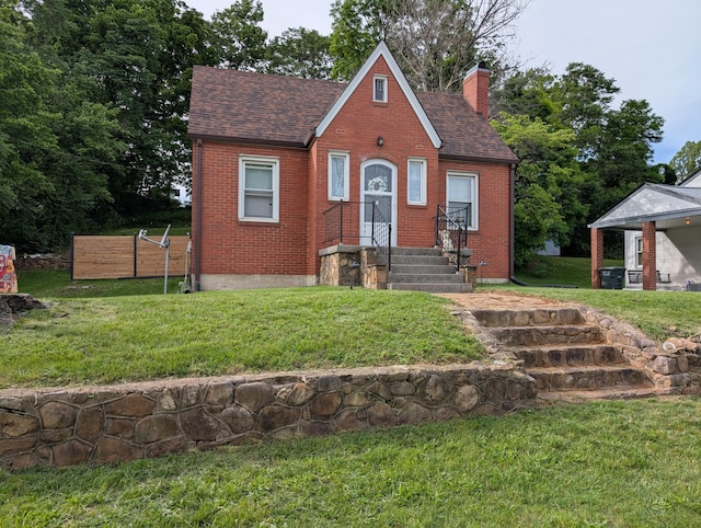 2221 W Main St, Salem, VA 24153 - tudor home with a shingled roof, a chimney, brick siding, and a front lawn