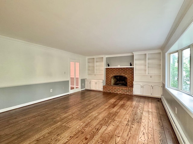 4867 Hunting Hills Dr, Roanoke, VA 24018 - unfurnished living room with a baseboard heating unit, wood finished floors, built in shelves, ornamental molding, and a brick fireplace