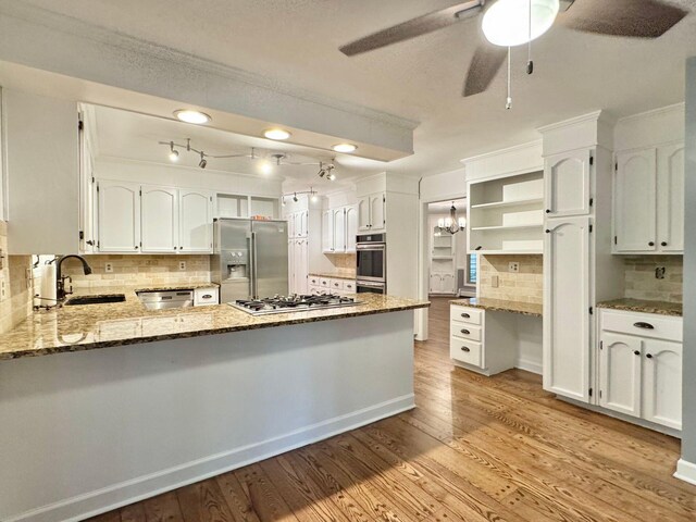4867 Hunting Hills Dr, Roanoke, VA 24018 - kitchen featuring appliances with stainless steel finishes, a sink, open shelves, a peninsula, and decorative backsplash