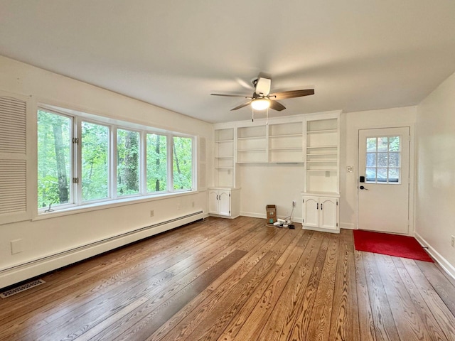 4867 Hunting Hills Dr, Roanoke, VA 24018 - unfurnished living room featuring a baseboard radiator, ceiling fan, wood-type flooring, and baseboards