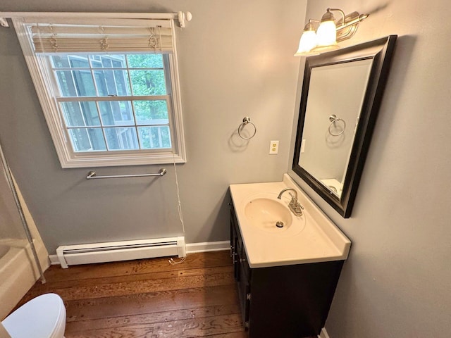 4867 Hunting Hills Dr, Roanoke, VA 24018 - full bath featuring baseboard heating, vanity, wood finished floors, baseboards, and toilet