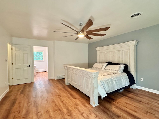 4867 Hunting Hills Dr, Roanoke, VA 24018 - bedroom featuring a baseboard heating unit, light wood-type flooring, baseboards, and a ceiling fan