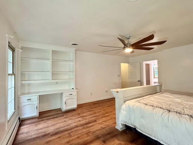 4867 Hunting Hills Dr, Roanoke, VA 24018 - bedroom featuring a baseboard heating unit, light wood-style flooring, baseboards, and multiple windows