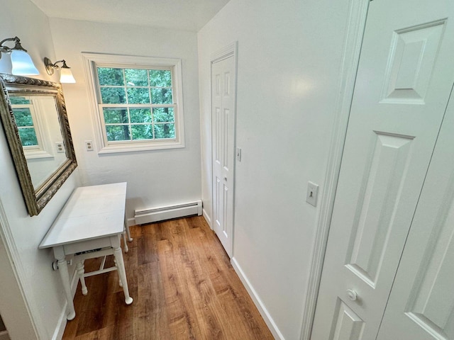 4867 Hunting Hills Dr, Roanoke, VA 24018 - hallway featuring baseboard heating, wood finished floors, and baseboards