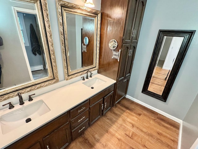 4867 Hunting Hills Dr, Roanoke, VA 24018 - bathroom featuring double vanity, wood finished floors, baseboards, and baseboard heating