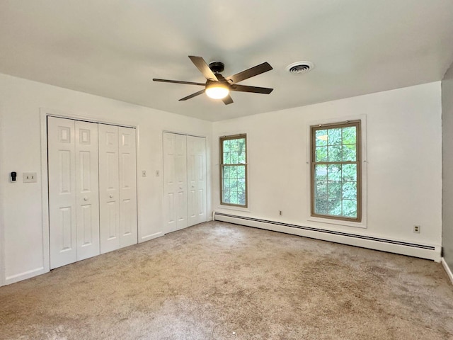 4867 Hunting Hills Dr, Roanoke, VA 24018 - unfurnished bedroom with baseboard heating, multiple closets, carpet floors, and baseboards