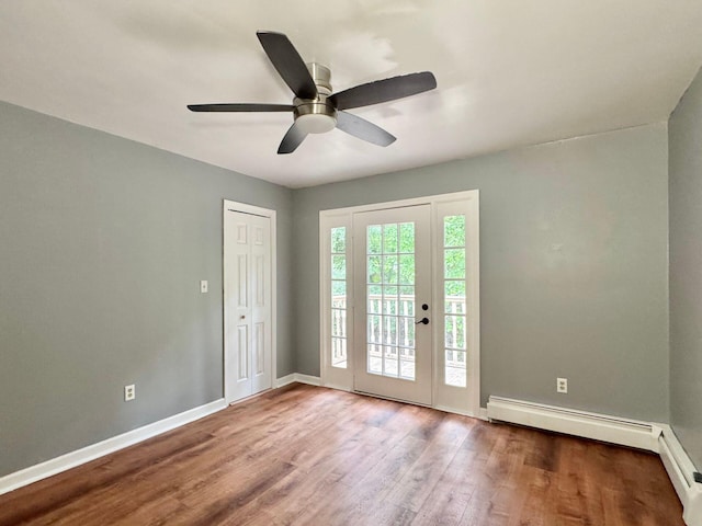 4867 Hunting Hills Dr, Roanoke, VA 24018 - spare room featuring wood finished floors, ceiling fan, baseboards, and baseboard heating