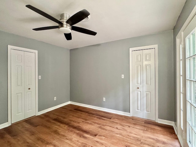 4867 Hunting Hills Dr, Roanoke, VA 24018 - unfurnished bedroom featuring wood finished floors, baseboards, and a ceiling fan