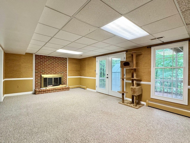 4867 Hunting Hills Dr, Roanoke, VA 24018 - unfurnished living room featuring carpet flooring, a baseboard heating unit, a paneled ceiling, french doors, and a brick fireplace