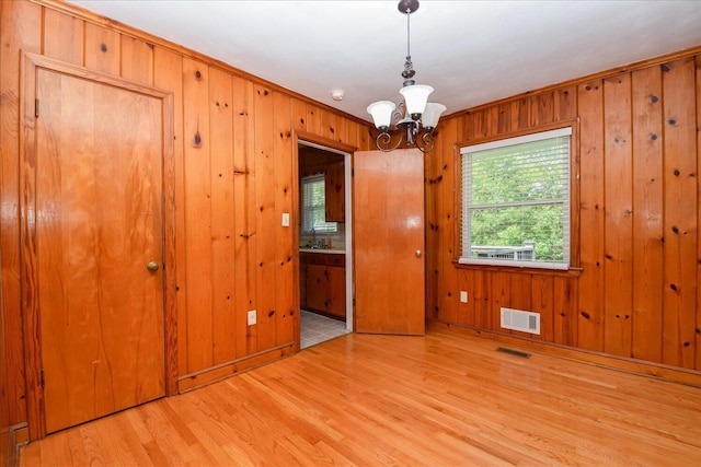 1008 Ridgecrest Dr, Roanoke, VA 24019 - spare room with wood finished floors, a chandelier, wooden walls, and crown molding