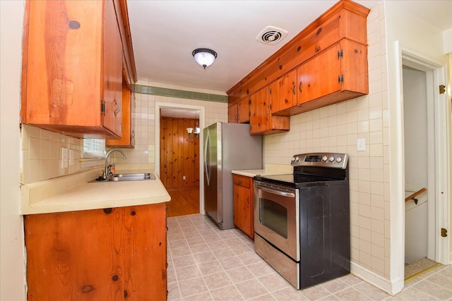 1008 Ridgecrest Dr, Roanoke, VA 24019 - kitchen featuring appliances with stainless steel finishes, a sink, light countertops, decorative backsplash, and brown cabinets