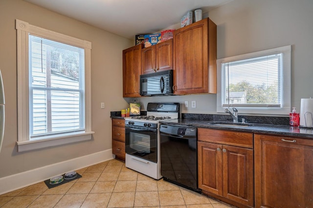515 Elm Ave SW, Roanoke, VA 24016 - kitchen featuring black appliances, a sink, light tile patterned floors, and brown cabinets