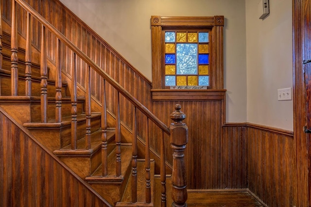 515 Elm Ave SW, Roanoke, VA 24016 - staircase featuring wainscoting, wooden walls, and wood finished floors