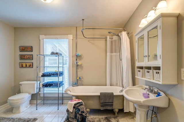 515 Elm Ave SW, Roanoke, VA 24016 - bathroom featuring baseboards, tile patterned floors, and toilet