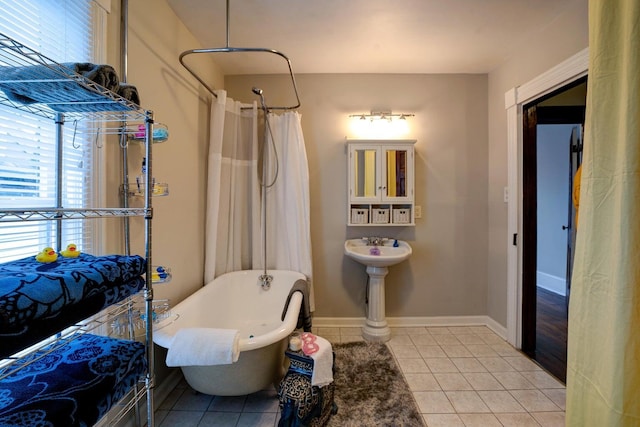 515 Elm Ave SW, Roanoke, VA 24016 - bathroom with tile patterned flooring, a soaking tub, curtained shower, and baseboards