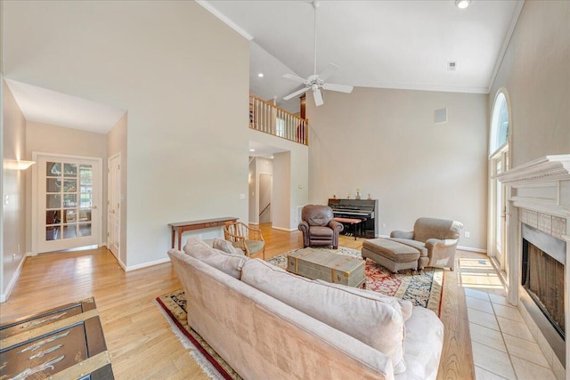 1425 Cravens Creek Ln SW, Roanoke, VA 24018 - living room with a tiled fireplace, ceiling fan, high vaulted ceiling, stairway, and baseboards