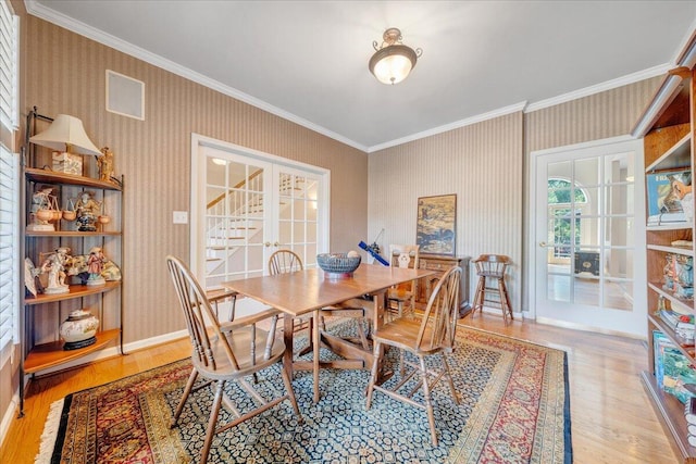 1425 Cravens Creek Ln SW, Roanoke, VA 24018 - dining room with ornamental molding, french doors, wallpapered walls, wood finished floors, and baseboards