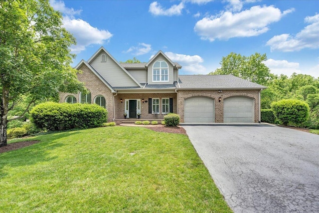1425 Cravens Creek Ln SW, Roanoke, VA 24018 - view of front of house featuring brick siding, a garage, driveway, a front lawn, and covered porch
