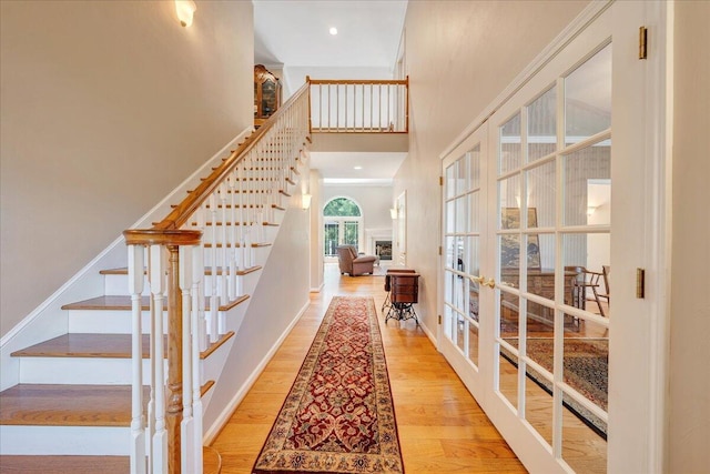 1425 Cravens Creek Ln SW, Roanoke, VA 24018 - entrance foyer with french doors, a high ceiling, stairs, wood finished floors, and baseboards