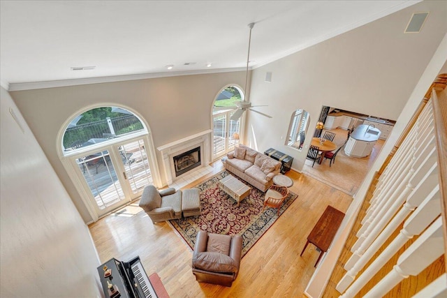 1425 Cravens Creek Ln SW, Roanoke, VA 24018 - living area with plenty of natural light, ornamental molding, a ceiling fan, wood finished floors, and a fireplace with flush hearth