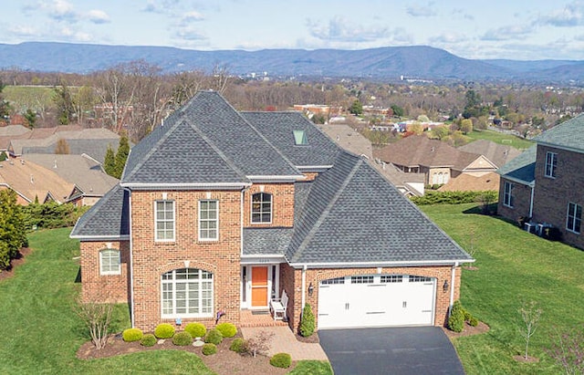 3205 Southwood Manor Ct, Roanoke, VA 24014 - colonial home featuring brick siding, a mountain view, a front lawn, and driveway