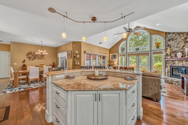 480 Winding Waters Dr, Moneta, VA 24121 - kitchen with open floor plan, hardwood / wood-style flooring, lofted ceiling, ceiling fan, and white cabinetry