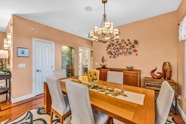 480 Winding Waters Dr, Moneta, VA 24121 - dining area featuring wood finished floors, a chandelier, and baseboards