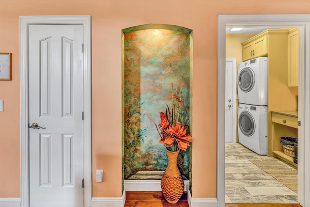 480 Winding Waters Dr, Moneta, VA 24121 - laundry room with stacked washing machine and dryer, cabinet space, light wood-style floors, and baseboards