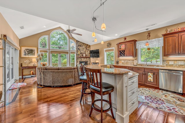 480 Winding Waters Dr, Moneta, VA 24121 - kitchen with dishwasher, open floor plan, a kitchen bar, light wood-style flooring, and vaulted ceiling