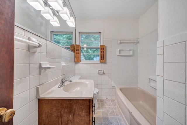 1113 Brandon Ave SW, Roanoke, VA 24015 - bathroom with tile patterned floors, toilet, tile walls, and vanity