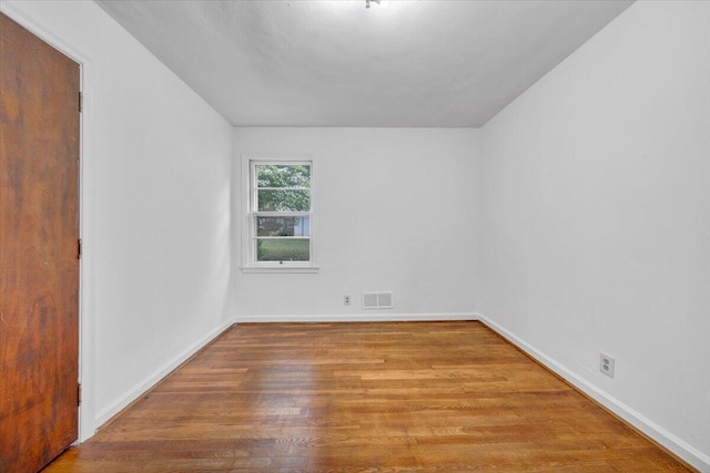 1113 Brandon Ave SW, Roanoke, VA 24015 - unfurnished room with wood finished floors, baseboards, and vaulted ceiling