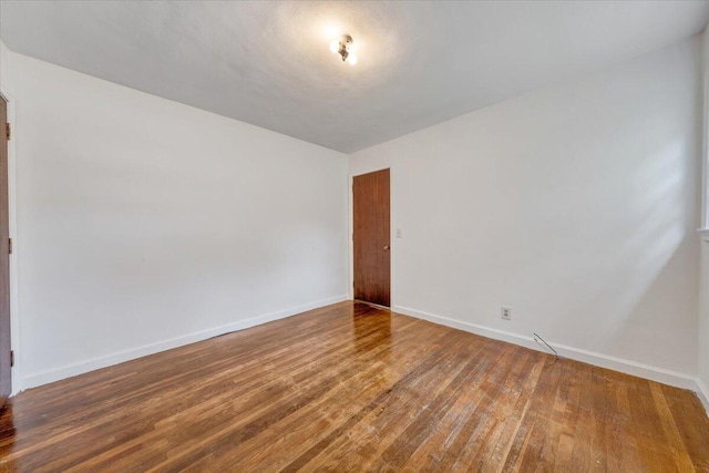 1113 Brandon Ave SW, Roanoke, VA 24015 - empty room with wood finished floors and baseboards