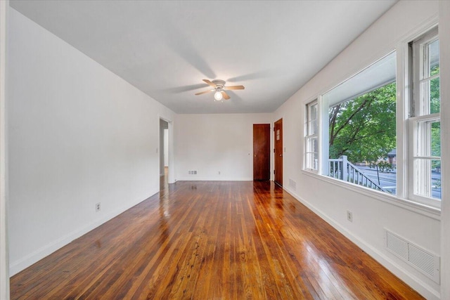 1113 Brandon Ave SW, Roanoke, VA 24015 - spare room featuring wood-type flooring, a ceiling fan, and baseboards