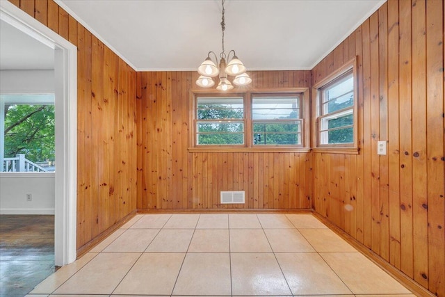 1113 Brandon Ave SW, Roanoke, VA 24015 - unfurnished dining area featuring healthy amount of natural light, a chandelier, wooden walls, baseboards, and ornamental molding