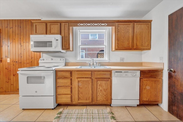 1113 Brandon Ave SW, Roanoke, VA 24015 - kitchen with white appliances, a sink, light tile patterned flooring, brown cabinetry, and light countertops